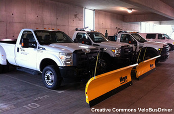 City snowplows parked in a garage, awaiting a snowstorm