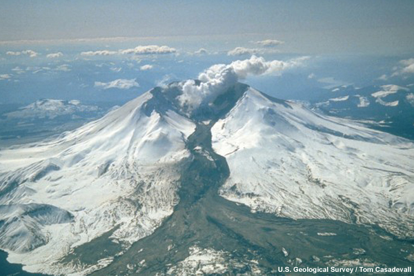 A lahar (the dark deposit on the snow) flowing from the crater of Mt St Helens into the North Fork Toutle River valley.