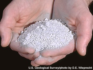 Volcanic ash scooped in a person's hands.