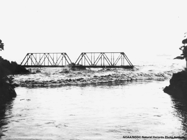 A tsunami bore, or sheer stepped wave, rolls into the Wailuku River during the 1946 tsunami in Hawaii.