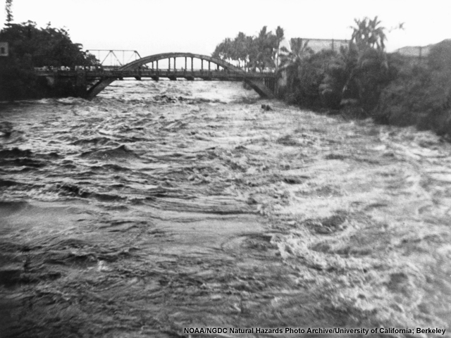 A tsunami wave surges up the Wailuku River in Hawaii after the 1946 Alaska tsunami.