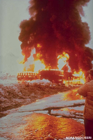 Oil tanks on fire at Valdez following the 1964 earthquake and tsunami