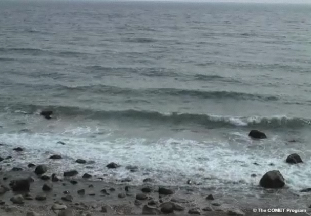 Waves rolling in to shore and breaking