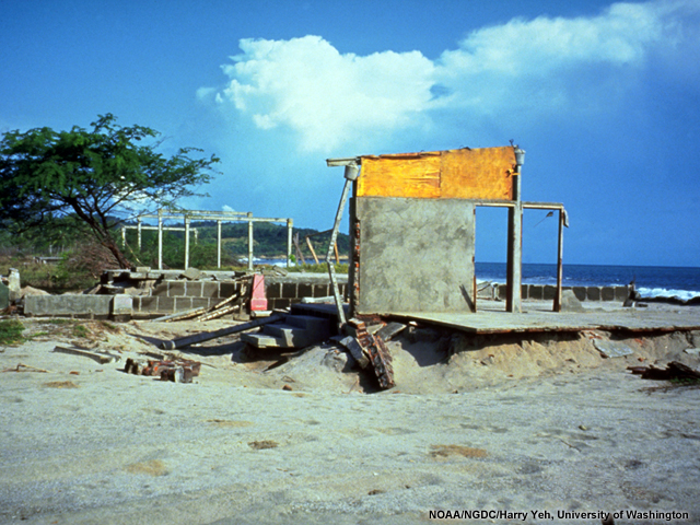Structures at El Popoyo, Nicaragua, where fifteen people lost their lives in a 1992 tsunami. Waves at this location reached a height of 5.6 m. One wall and a foundation are all that remain of a house that was entirely removed by the tsunami at El Popoyo, Nicaragua. Repairs have begun to the structure on the right.