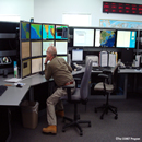 A man looks 
at a bank of 16 monitors at the Alaska and West Coast Tsunami Warning 
Center